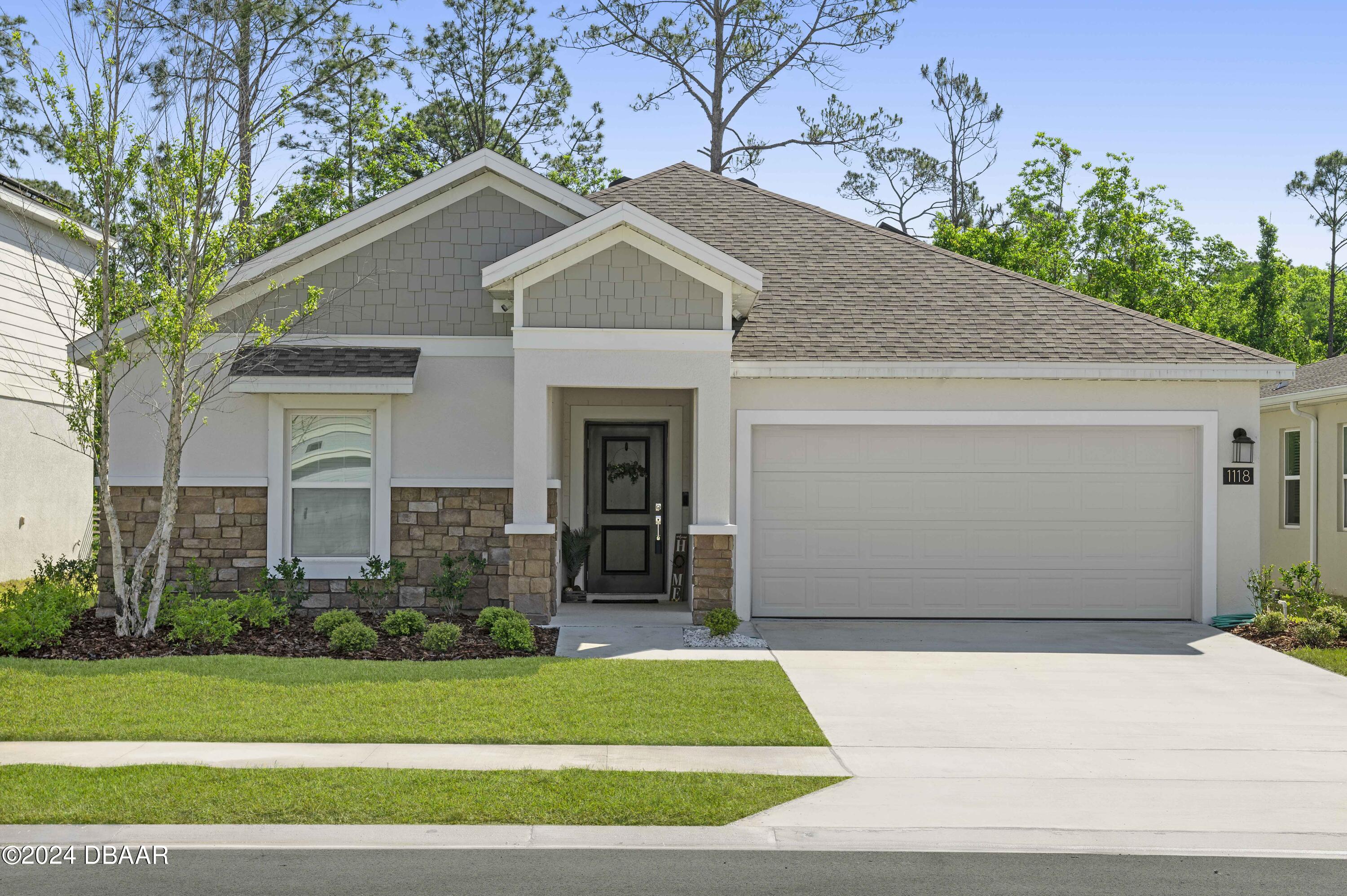 a front view of a house with a garden