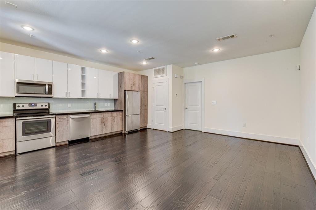 a view of kitchen with wooden floor and electronic appliances