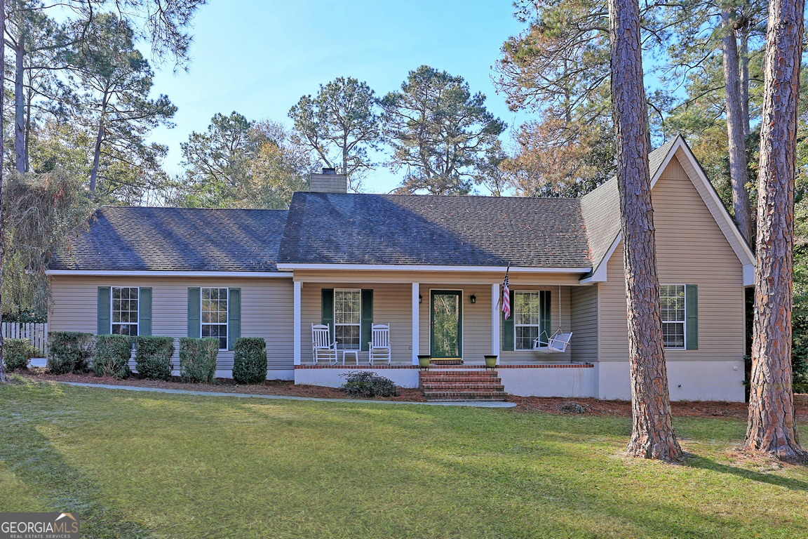 a front view of house with yard and green space