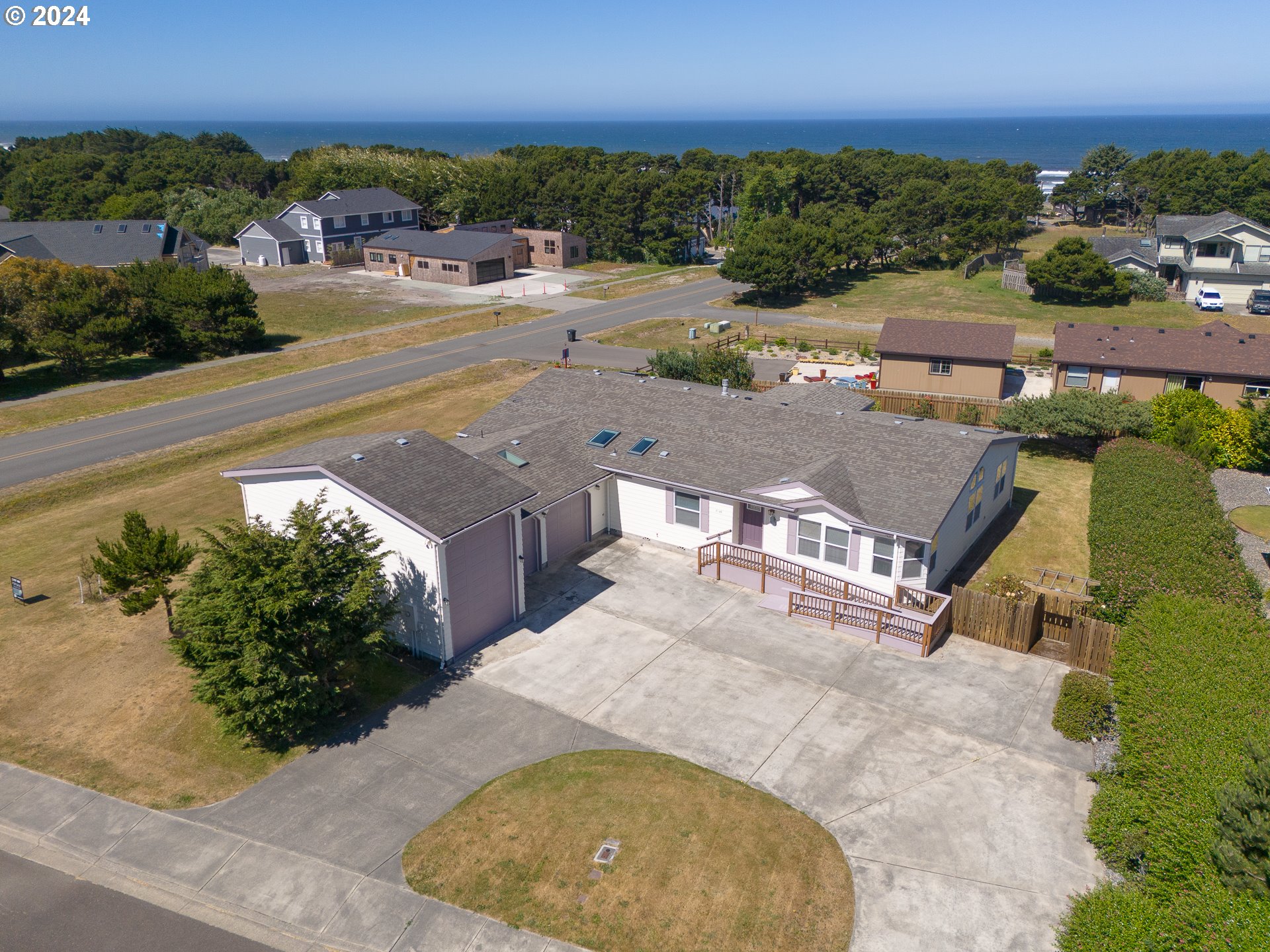 an aerial view of a house with a yard and lake view