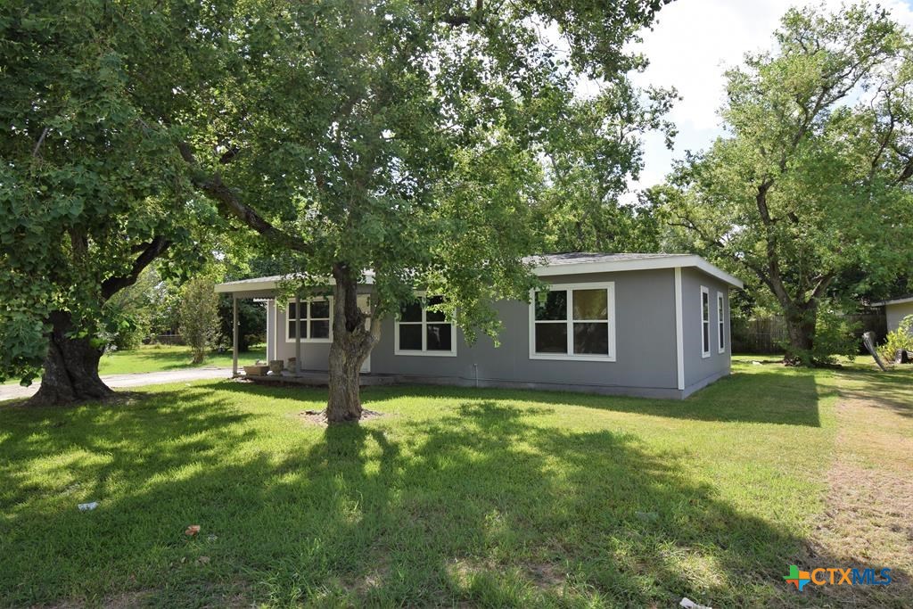 a view of a house with a yard porch and sitting area