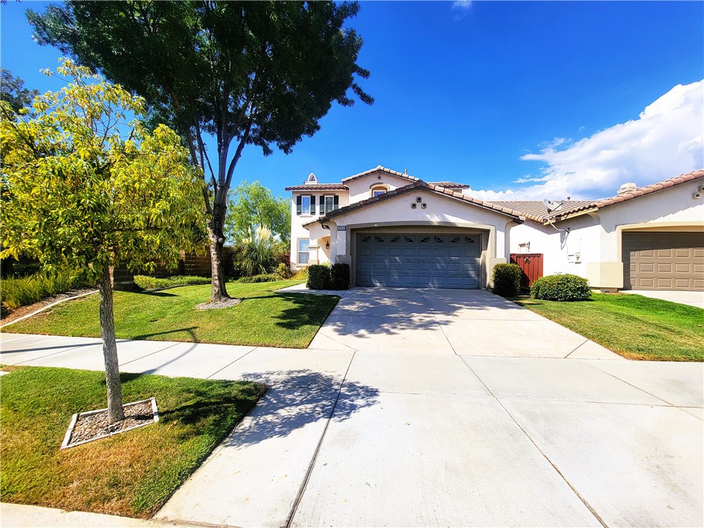 a view of a house with yard and tree s