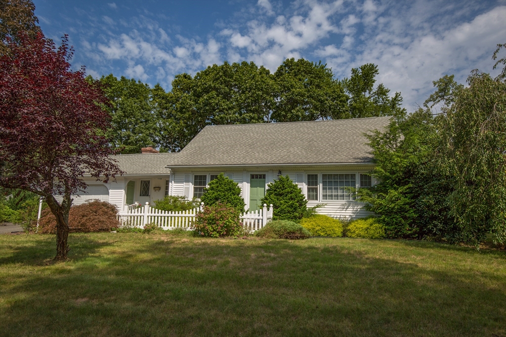 a front view of a house with a garden