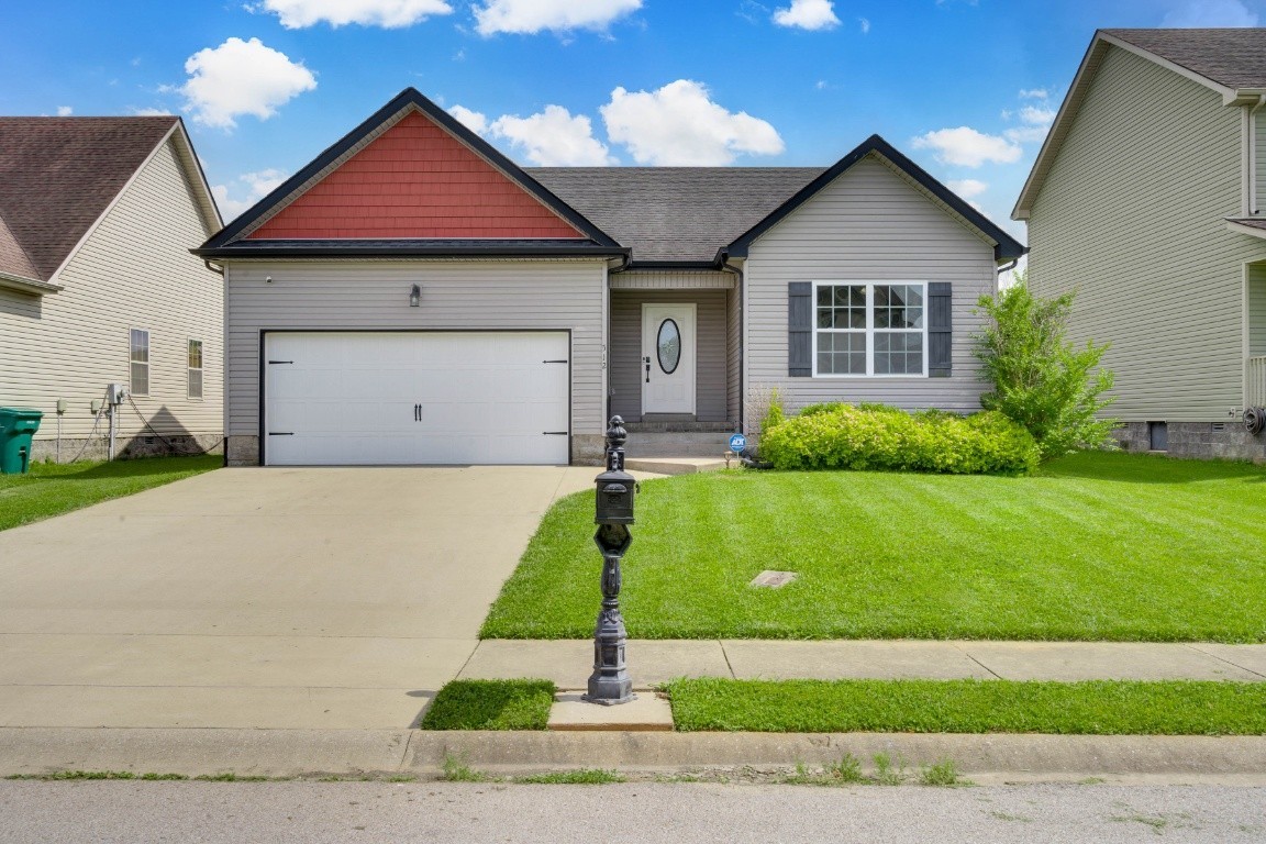 a front view of house with garage and yard