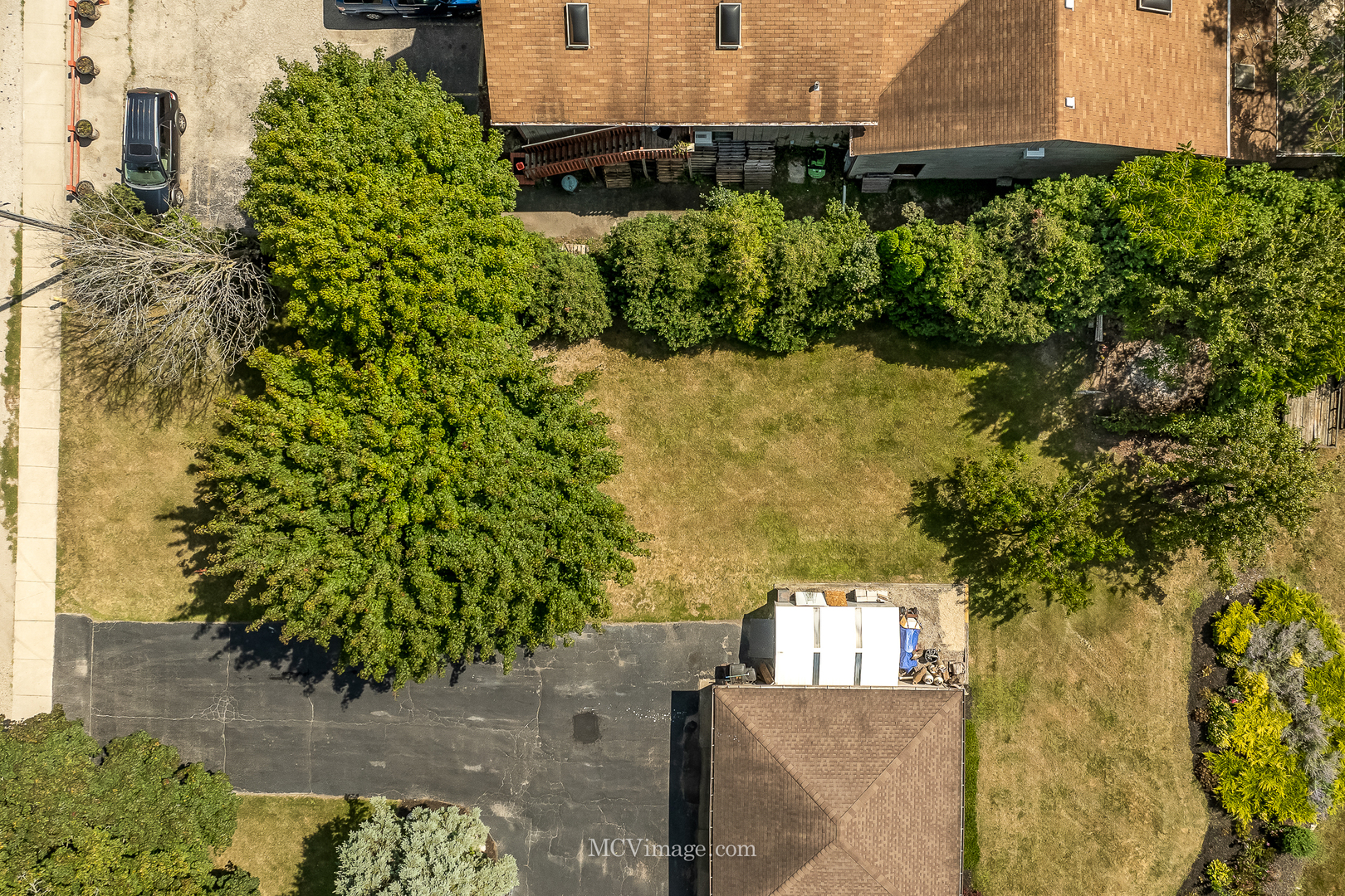 an aerial view of a house with a yard