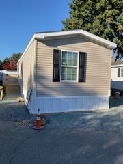 a view of a small house with backyard