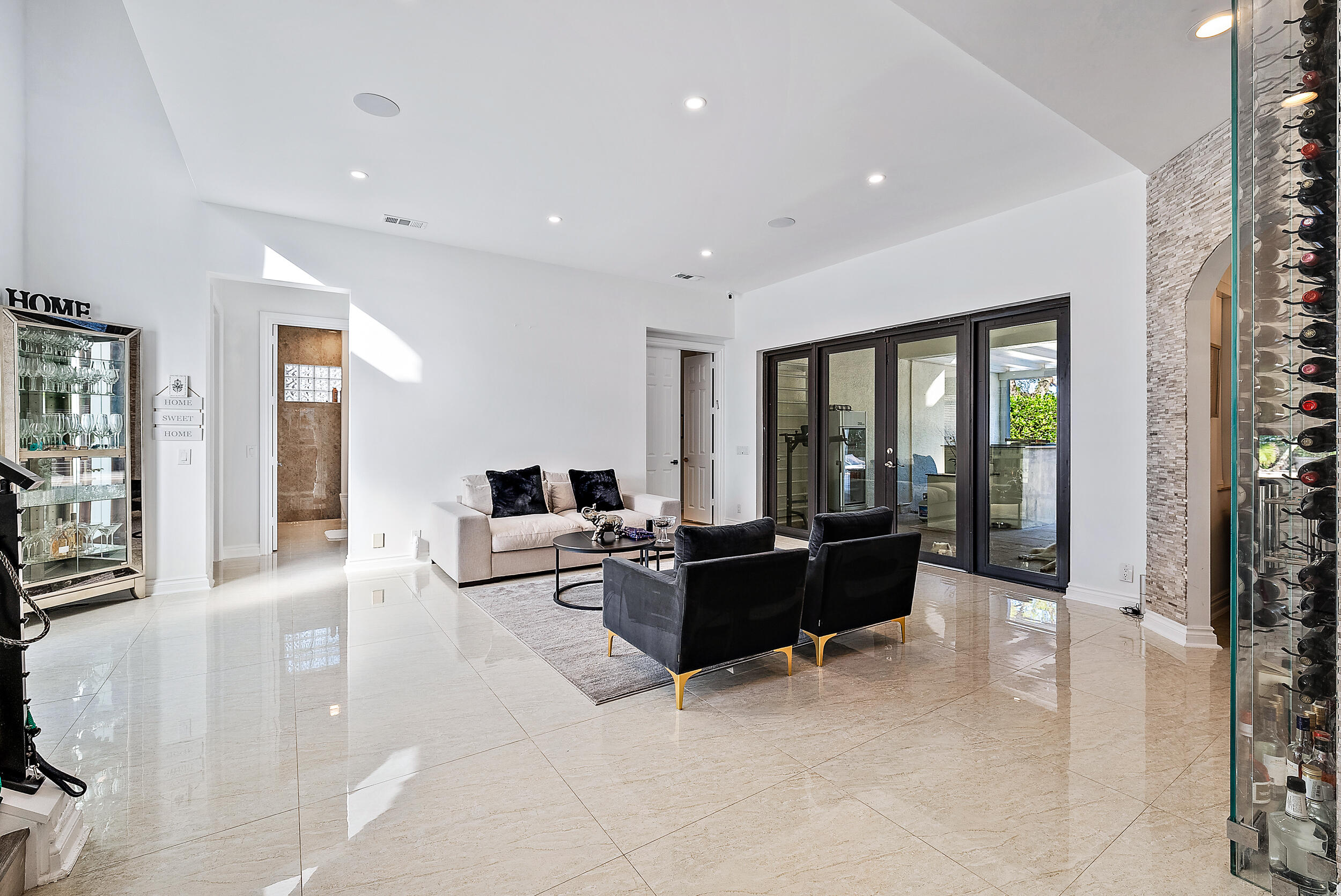 a living room with furniture large window and flat screen tv