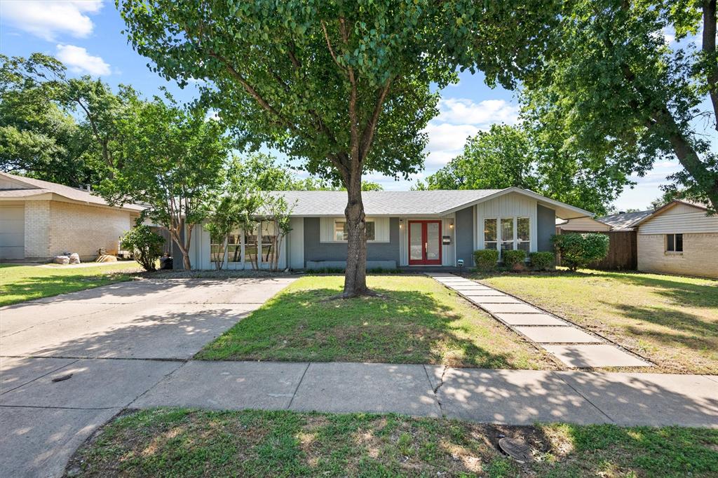 a front view of a house with yard patio and swimming pool