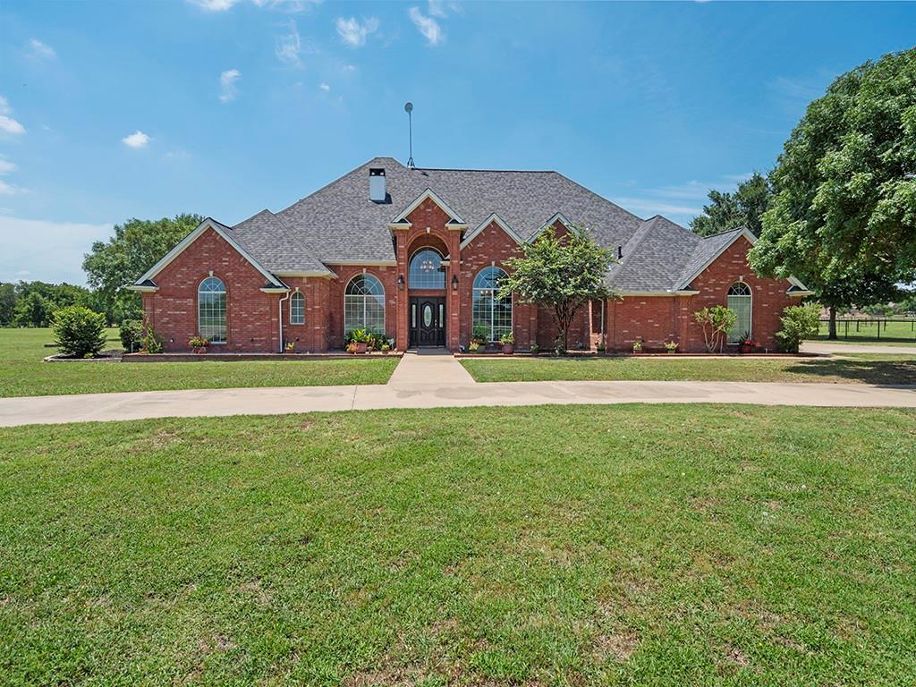 a front view of house with yard and green space