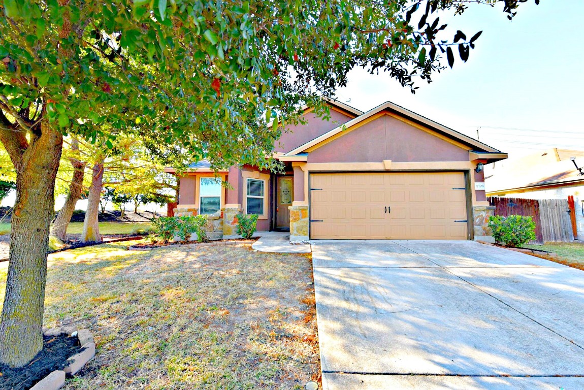 a view of a house with a yard and garage