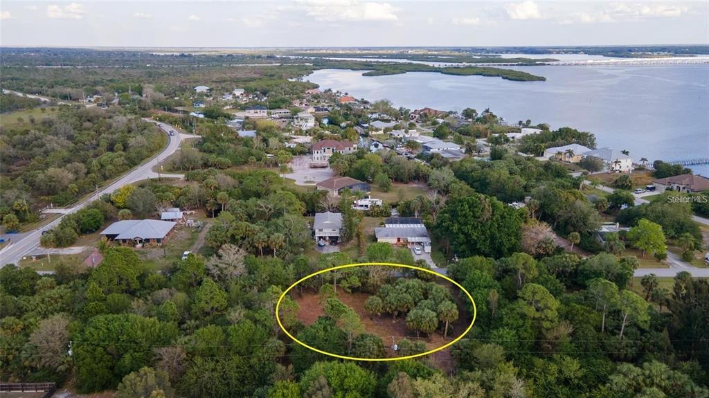 an aerial view of a house with a lake view