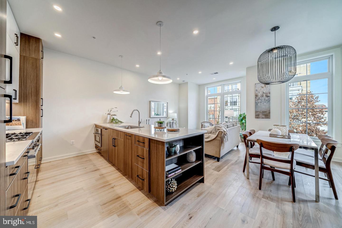 a kitchen with stainless steel appliances kitchen island a large island in the center