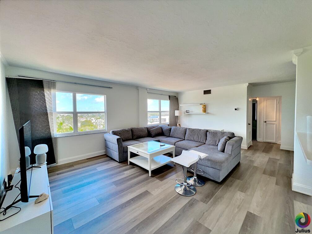 a living room with furniture and wooden floor