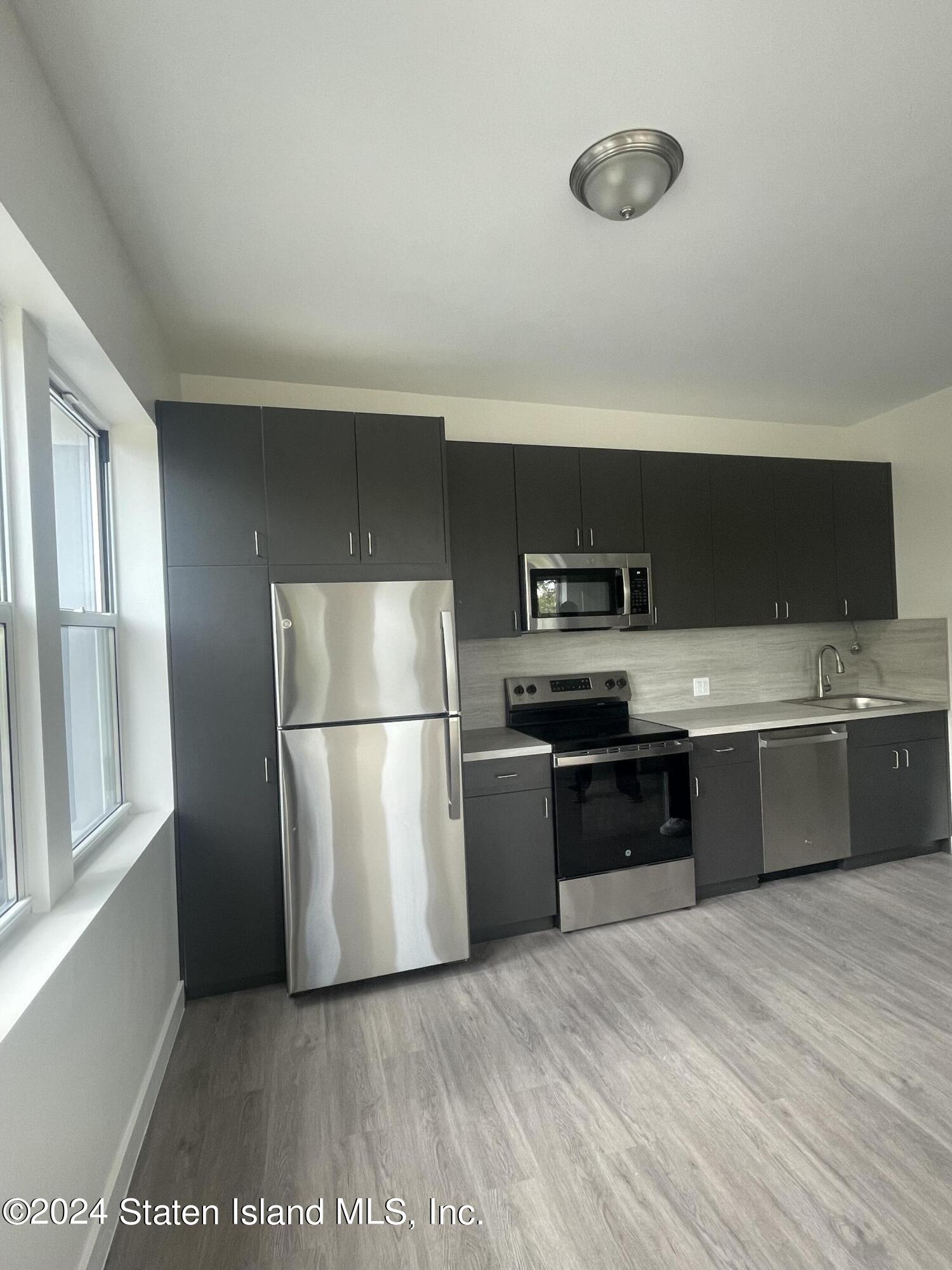 a kitchen with a refrigerator and a sink