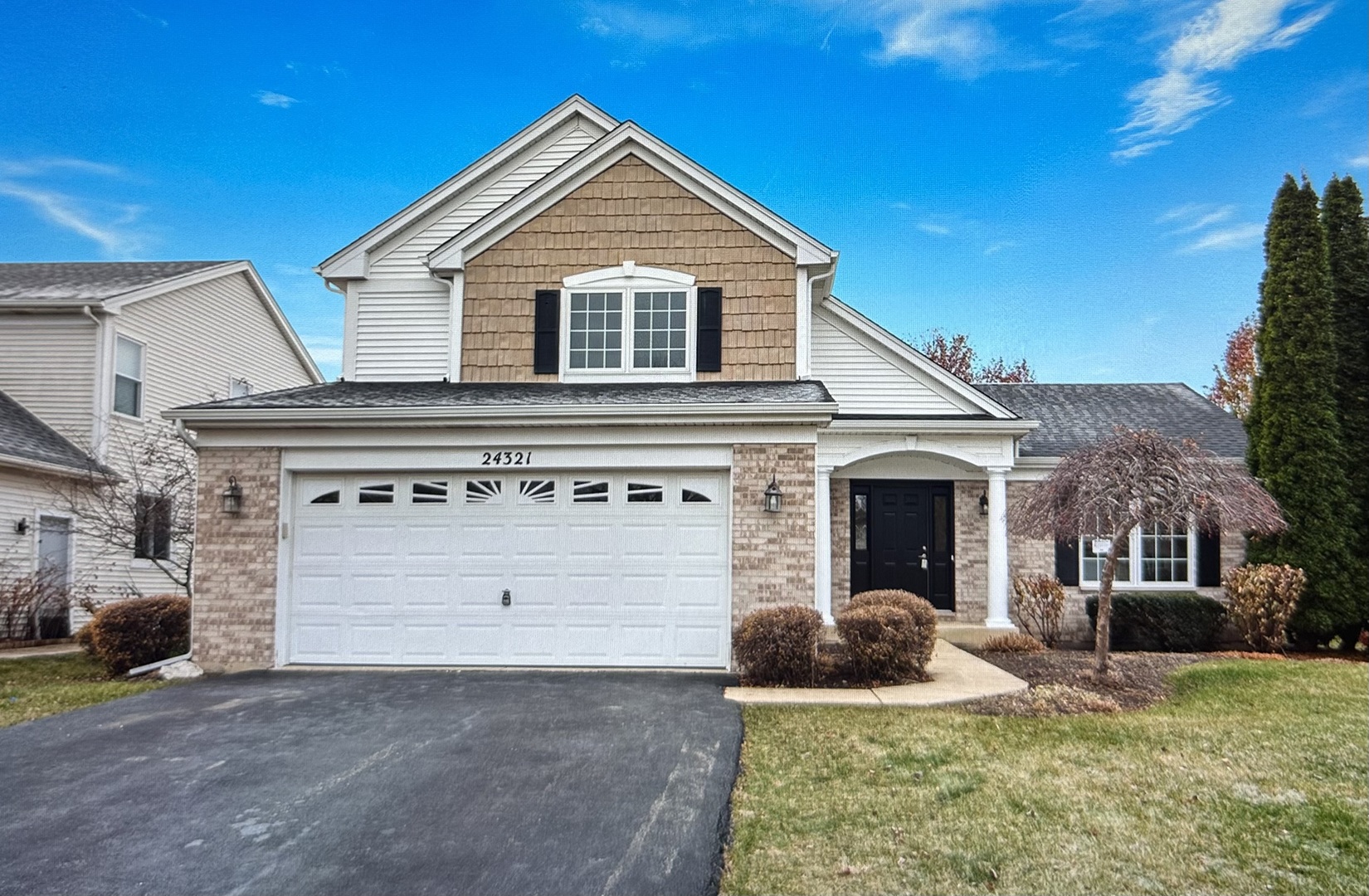 a front view of a house with a yard and garage