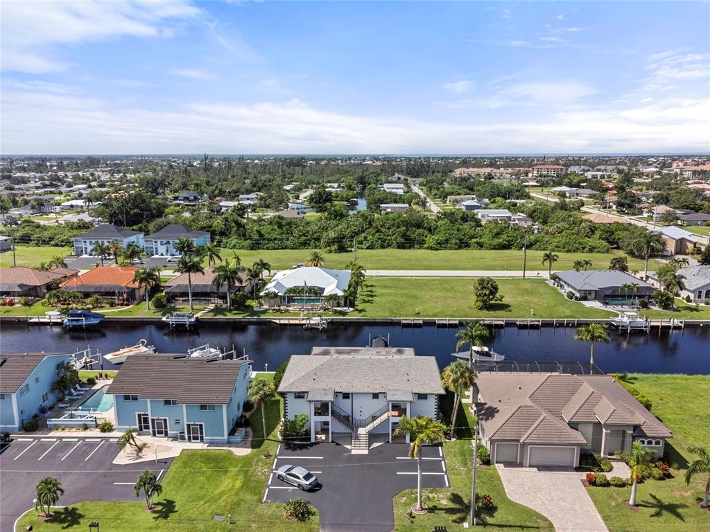 an aerial view of a houses with a lake