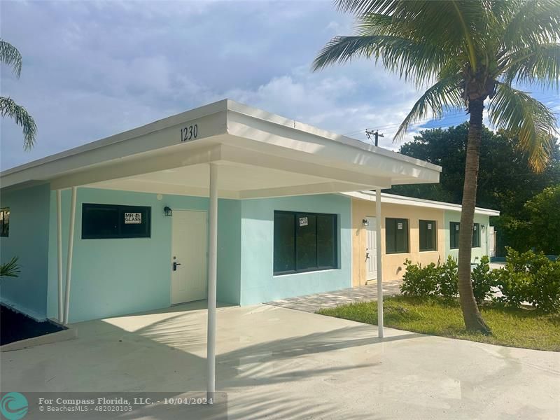 a view of a house with palm trees