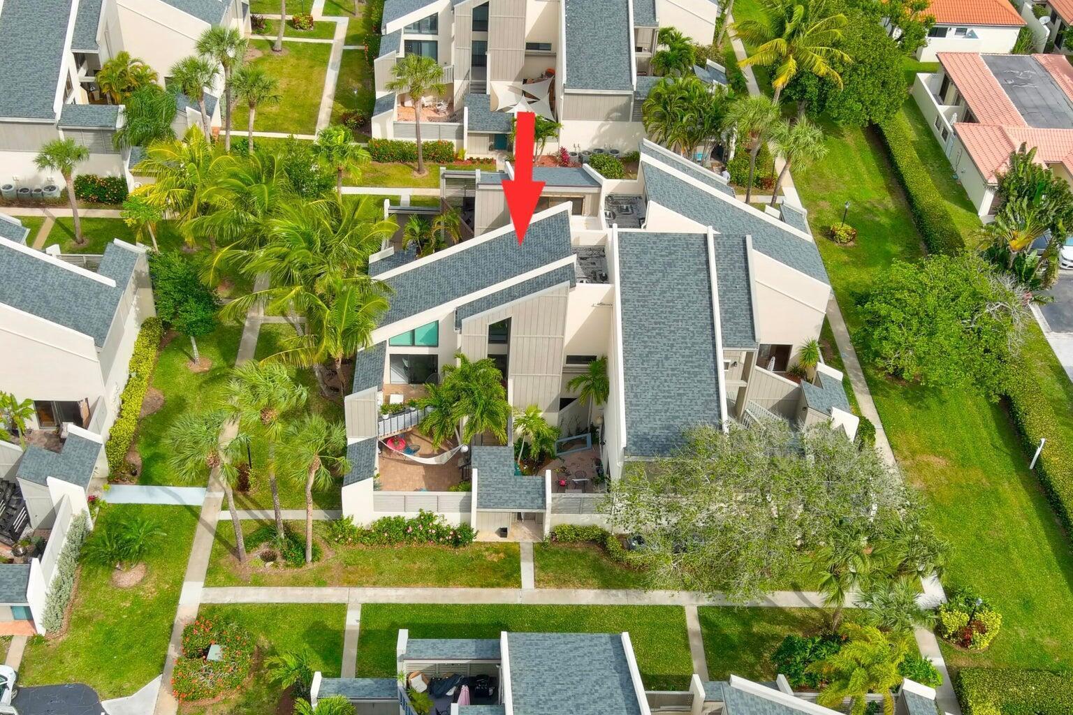 a aerial view of a house with a yard and potted plants