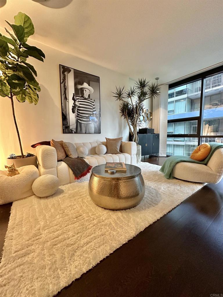 a bedroom with furniture and a large window