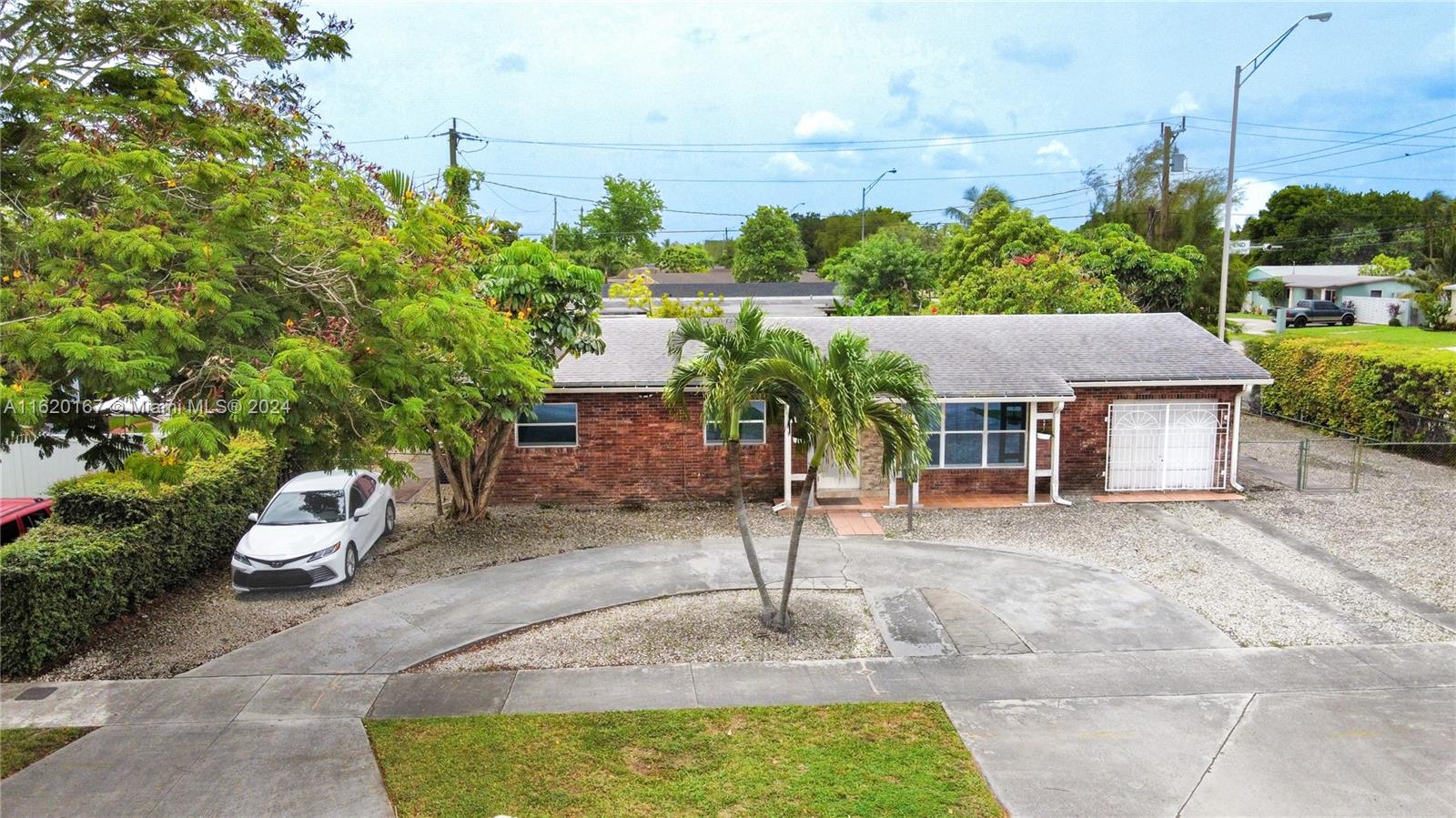 a house with lots of trees in the background