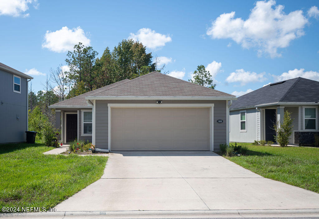 a front view of house with yard and green space