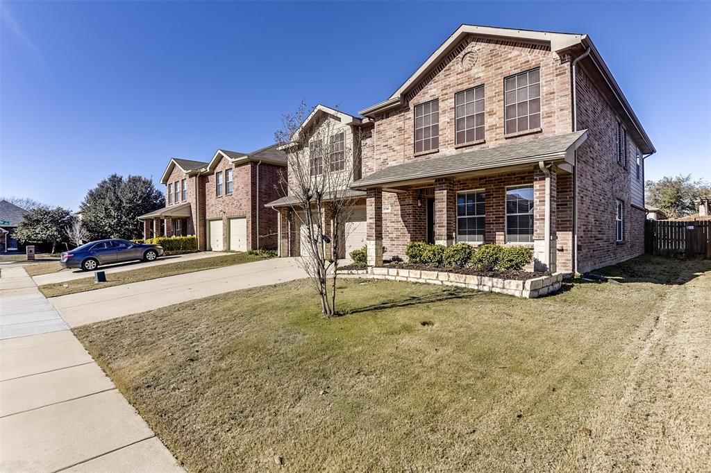 View of front of home with a front yard and a garage