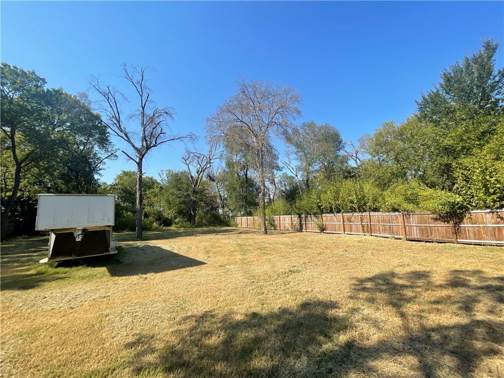 a view of empty space with swimming pool and trees