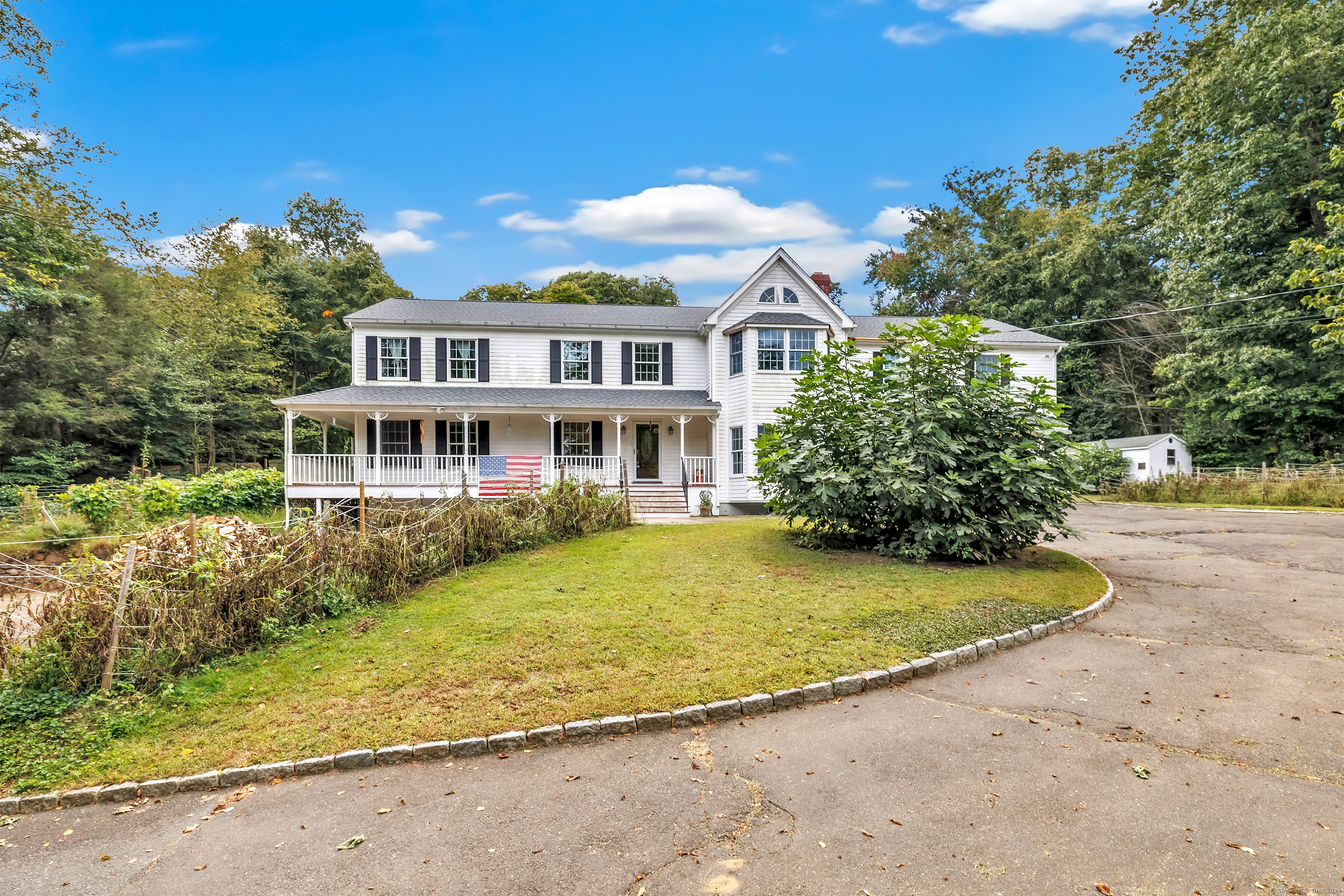 a front view of a house with a garden