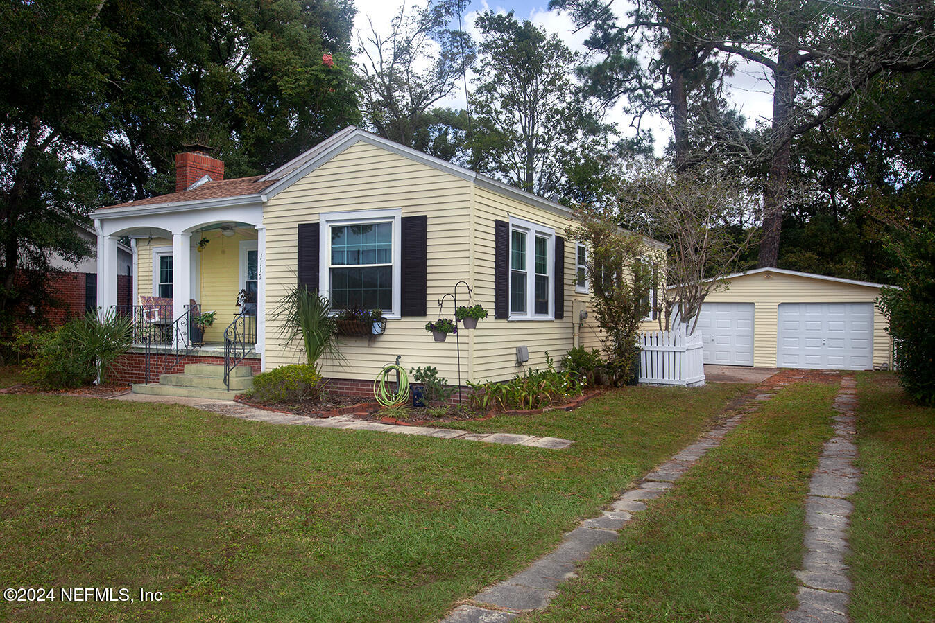 a front view of house with yard and green space