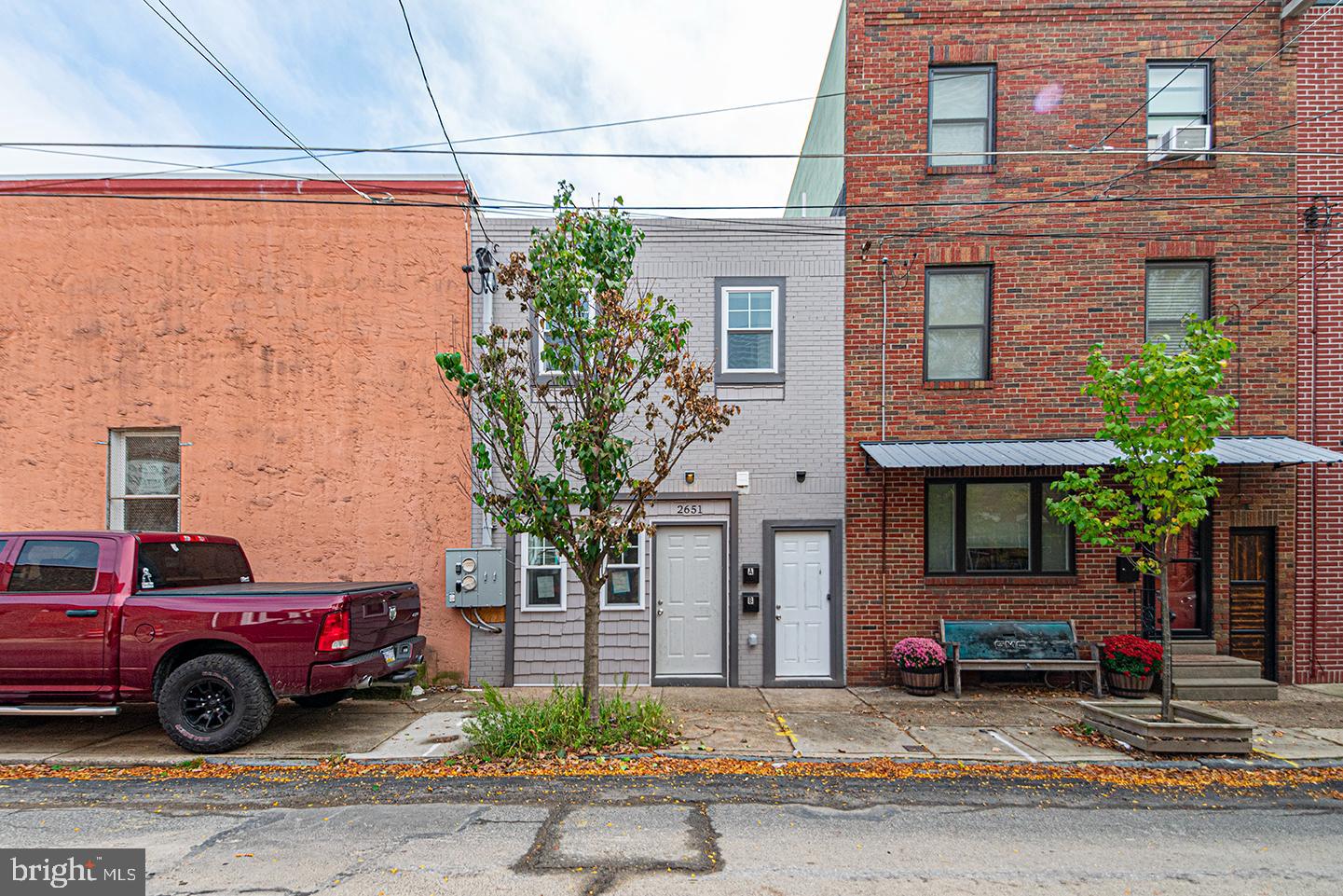 a view of a car is parked in front of a brick building