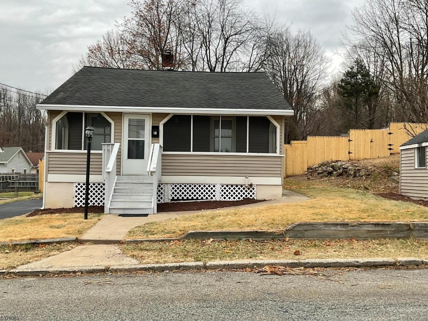 a view of a house with snow on the background