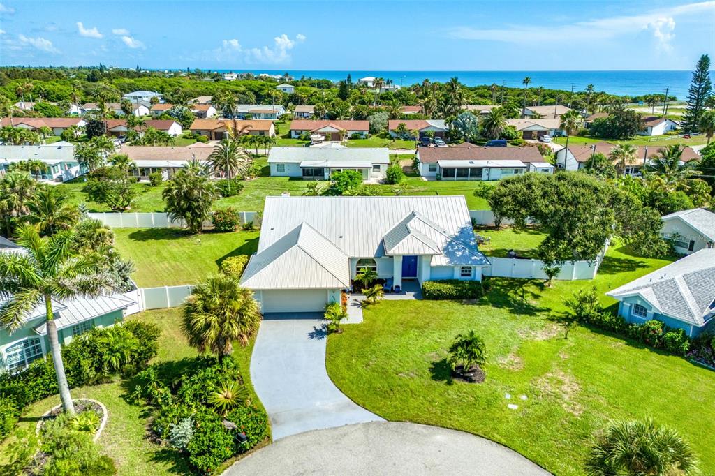 an aerial view of a house with a garden and lake view