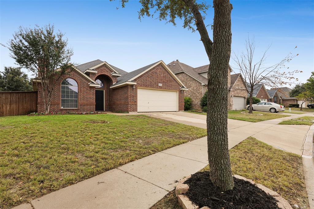 a front view of a house with a yard and pathway