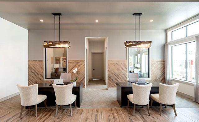 a dining room with furniture a chandelier and wooden floor