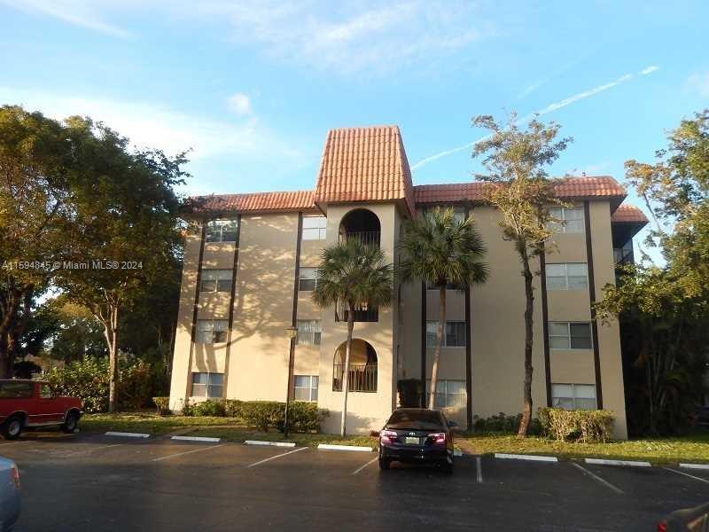 a front view of a building with parking