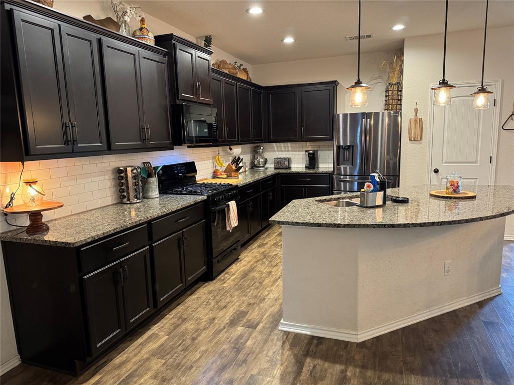 Elegant kitchen featuring premium granite countertops and ample, chic cabinetry for generous storage.