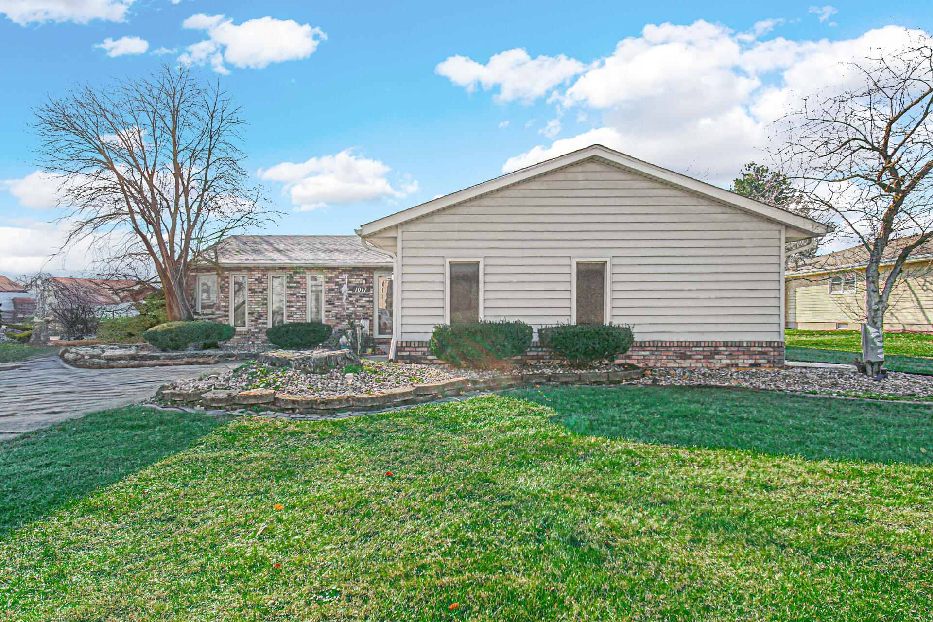 a view of a house with a yard and a garden