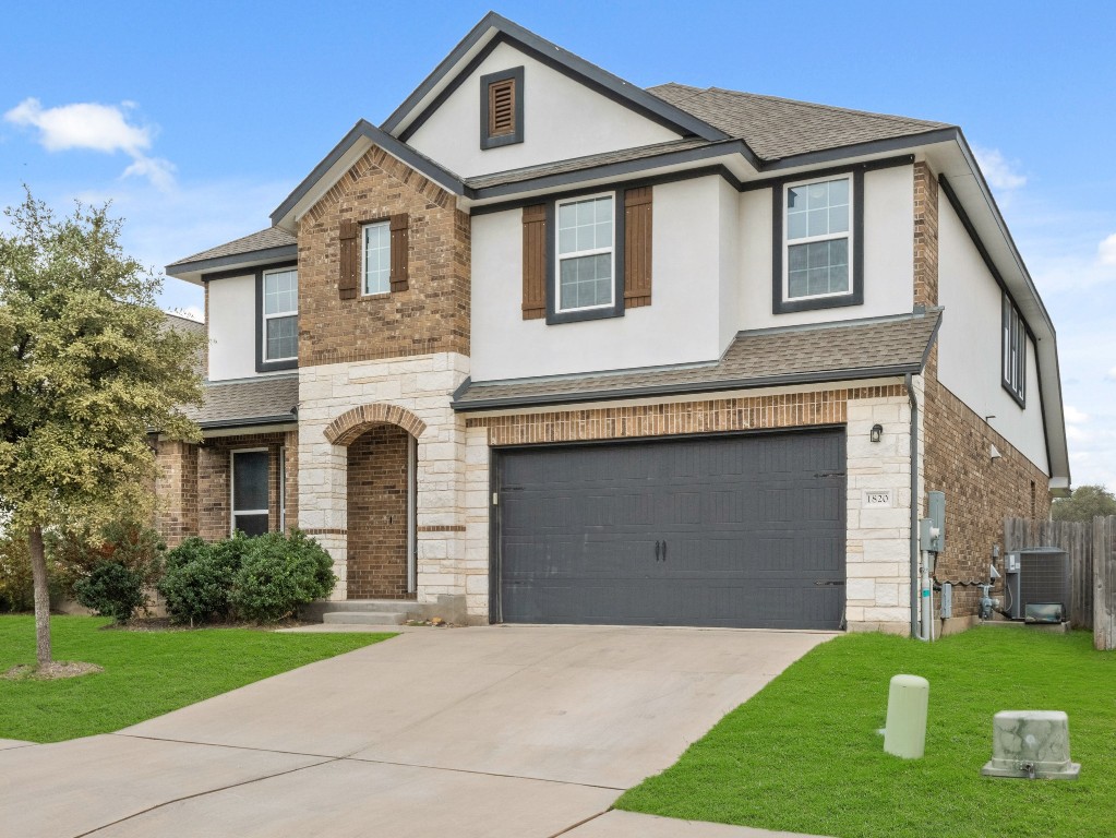 a front view of a house with a yard and garage