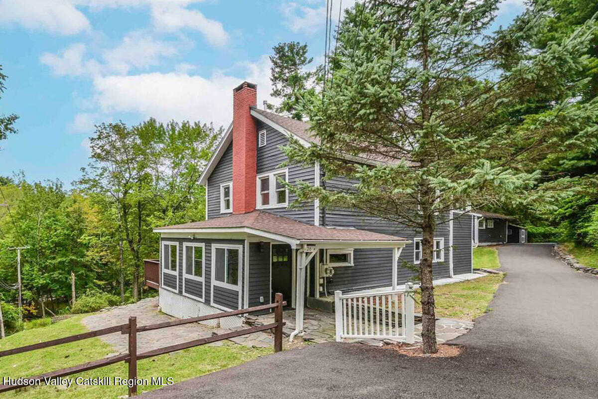 a view of a house with a yard and garden