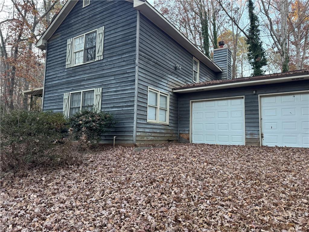 a backyard of a house with large trees