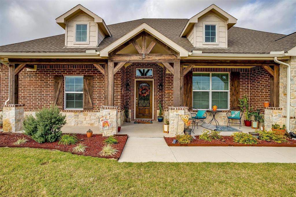 a front view of a house with garden and porch