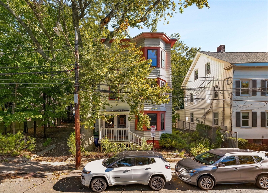 a front view of a building with parking space