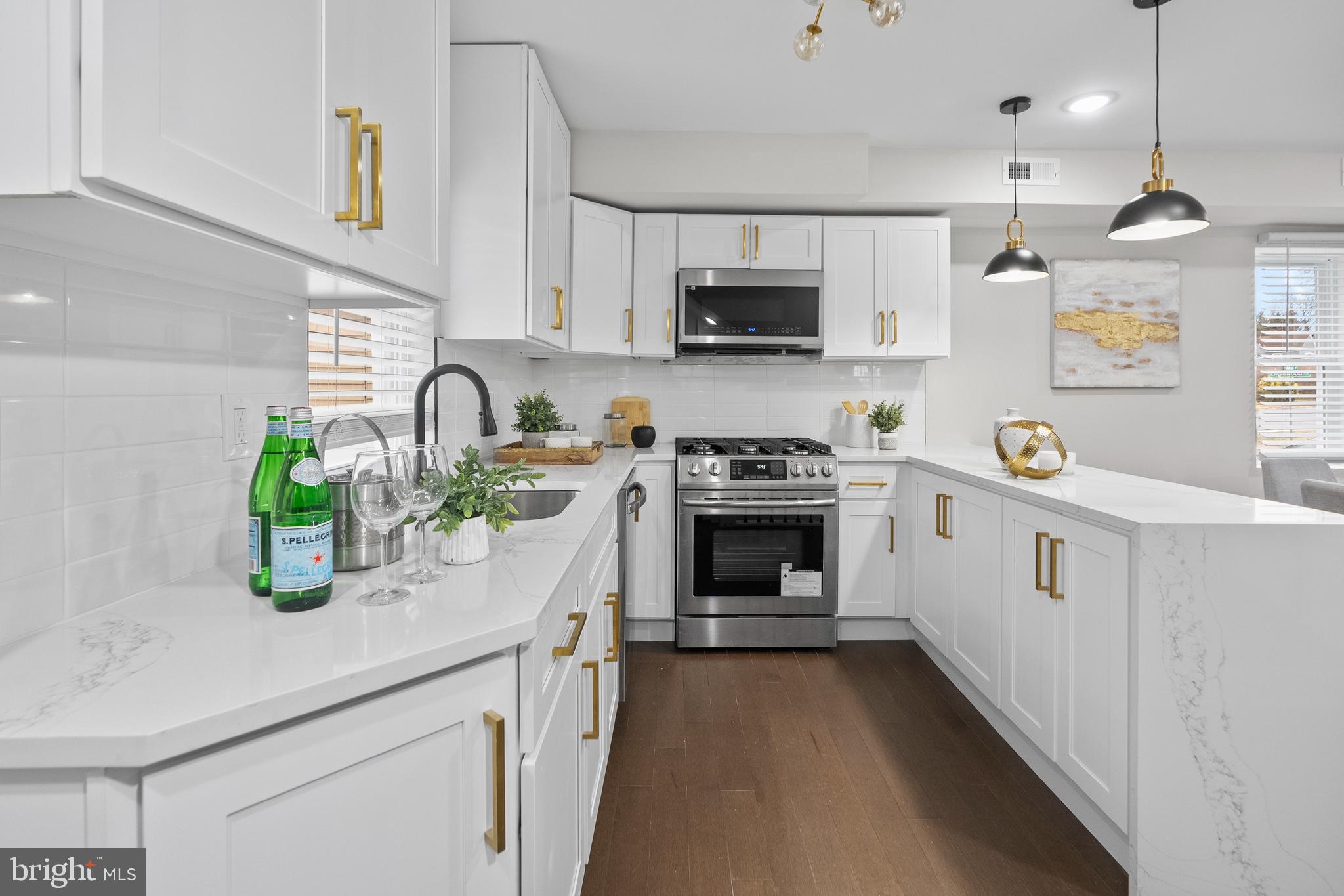 a kitchen with white cabinets and white appliances