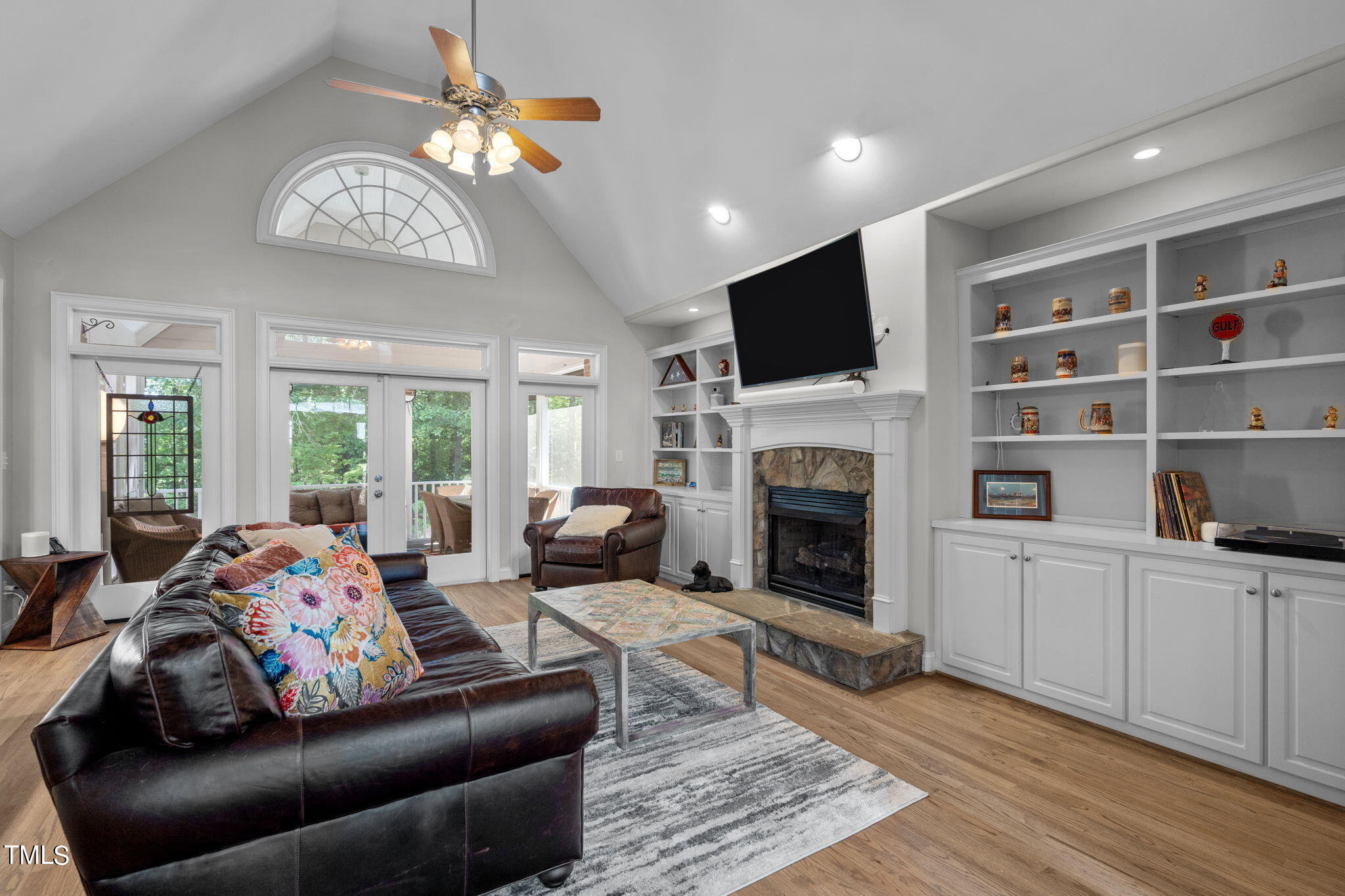 a living room with furniture a fireplace and a flat screen tv