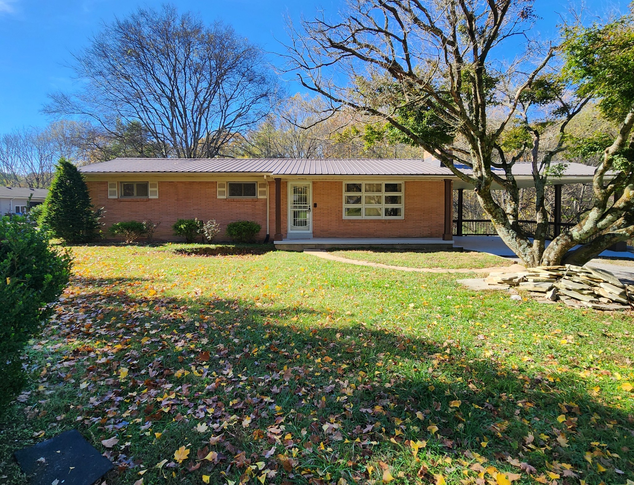 a front view of house with yard and green space