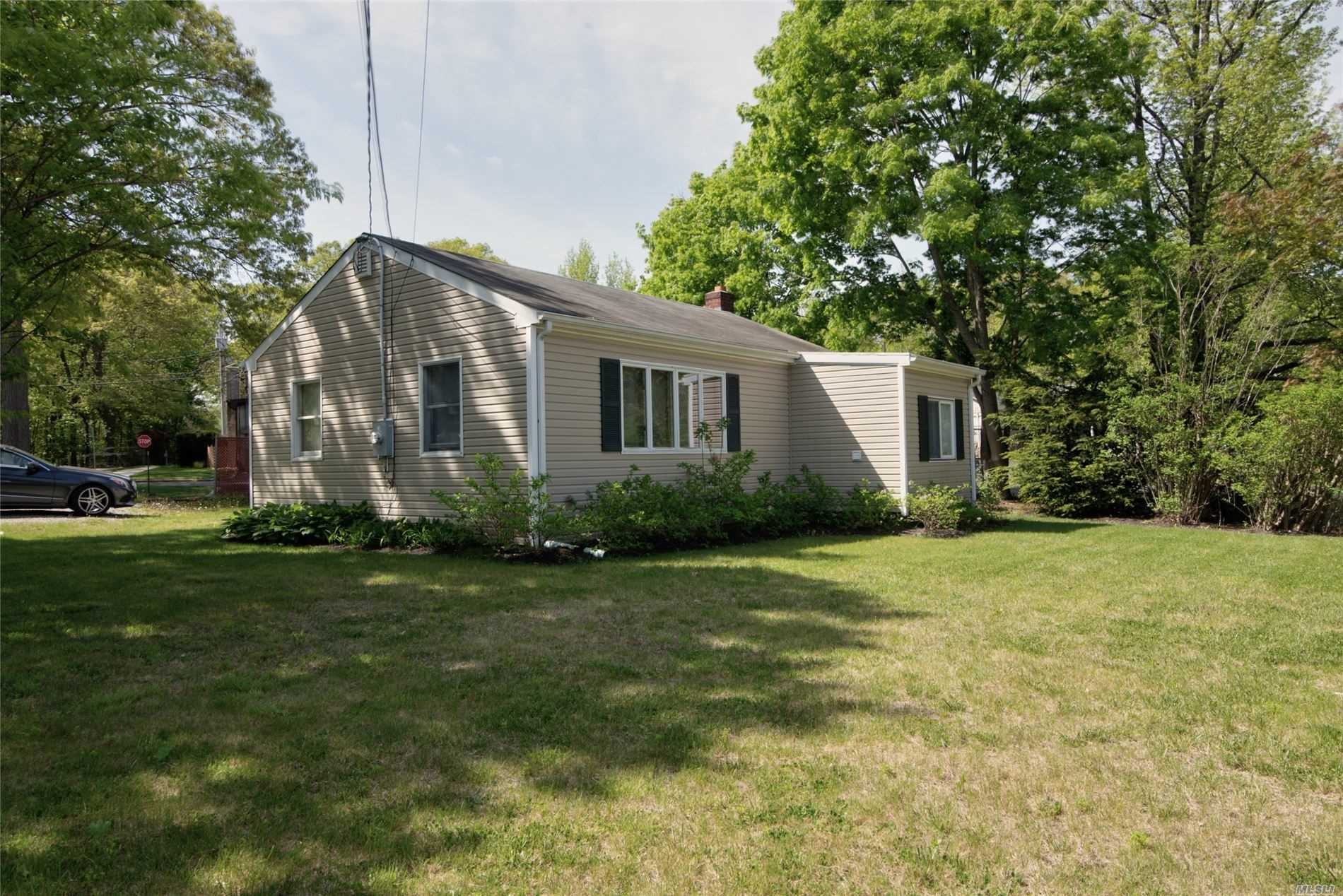 a front view of house with yard and green space