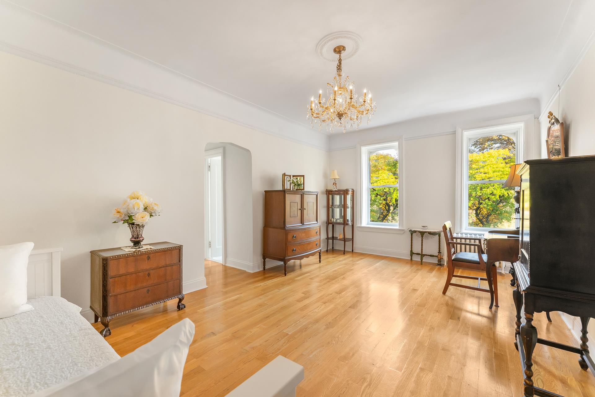 a living room with furniture and a chandelier