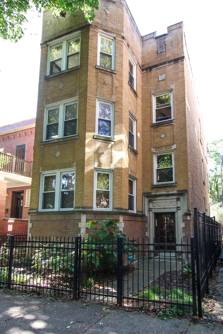 a view of a brick building next to a yard