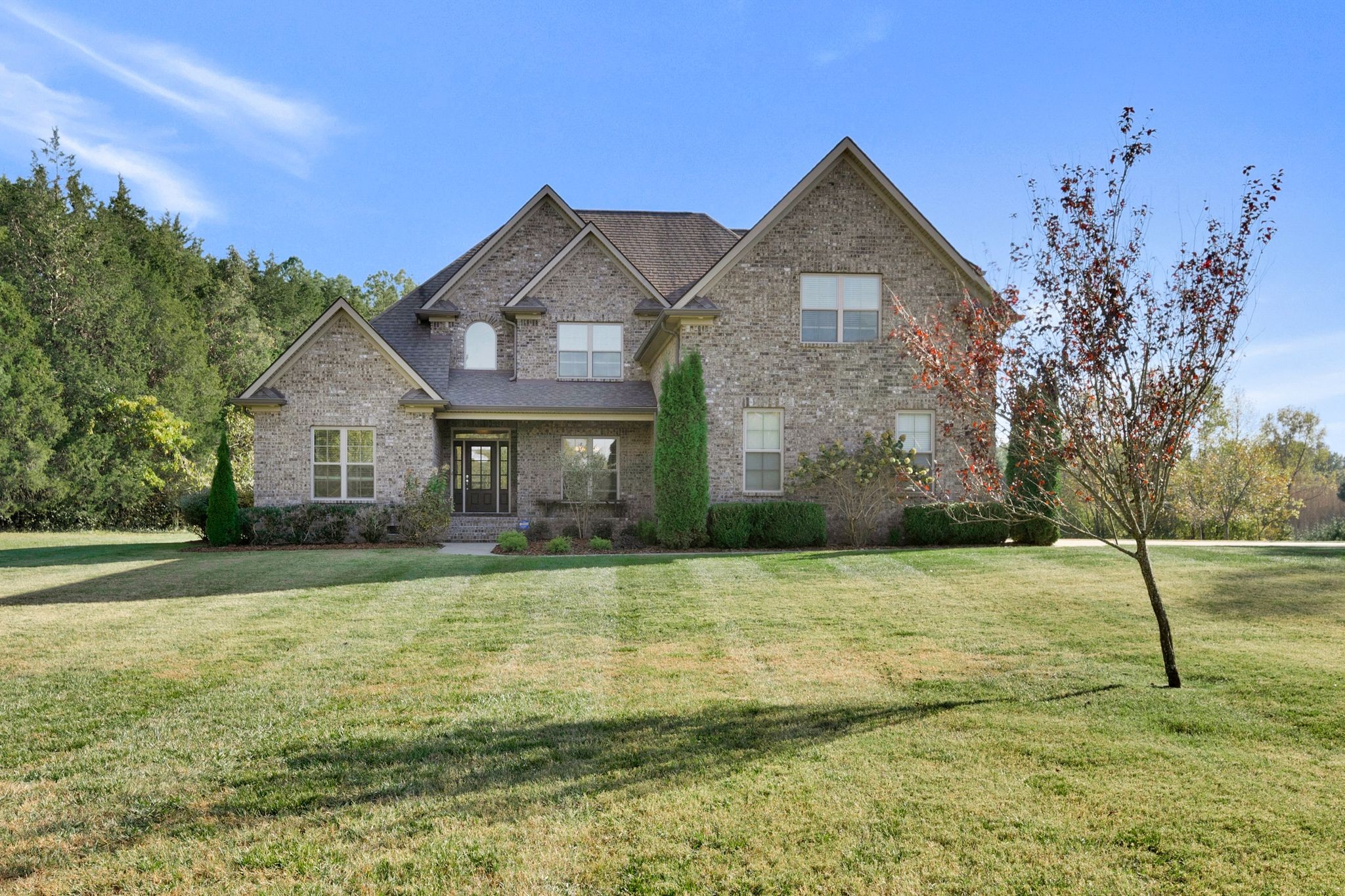 a front view of a house with a yard