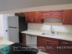 a kitchen with a sink and a refrigerator